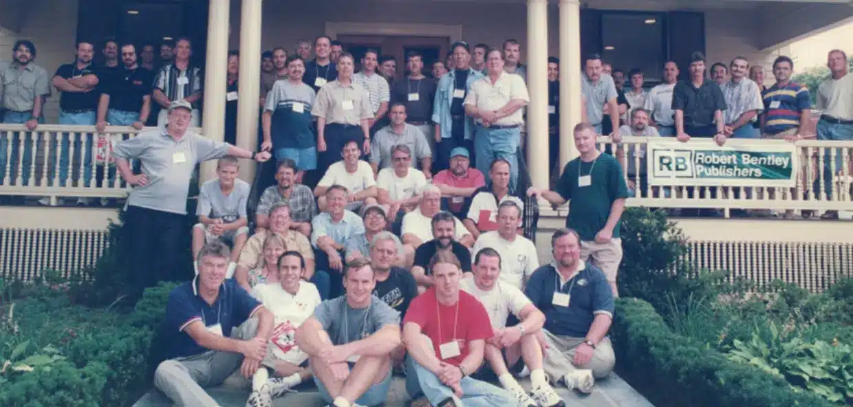 BIMRS history and a group of people sitting and standing in front of a building